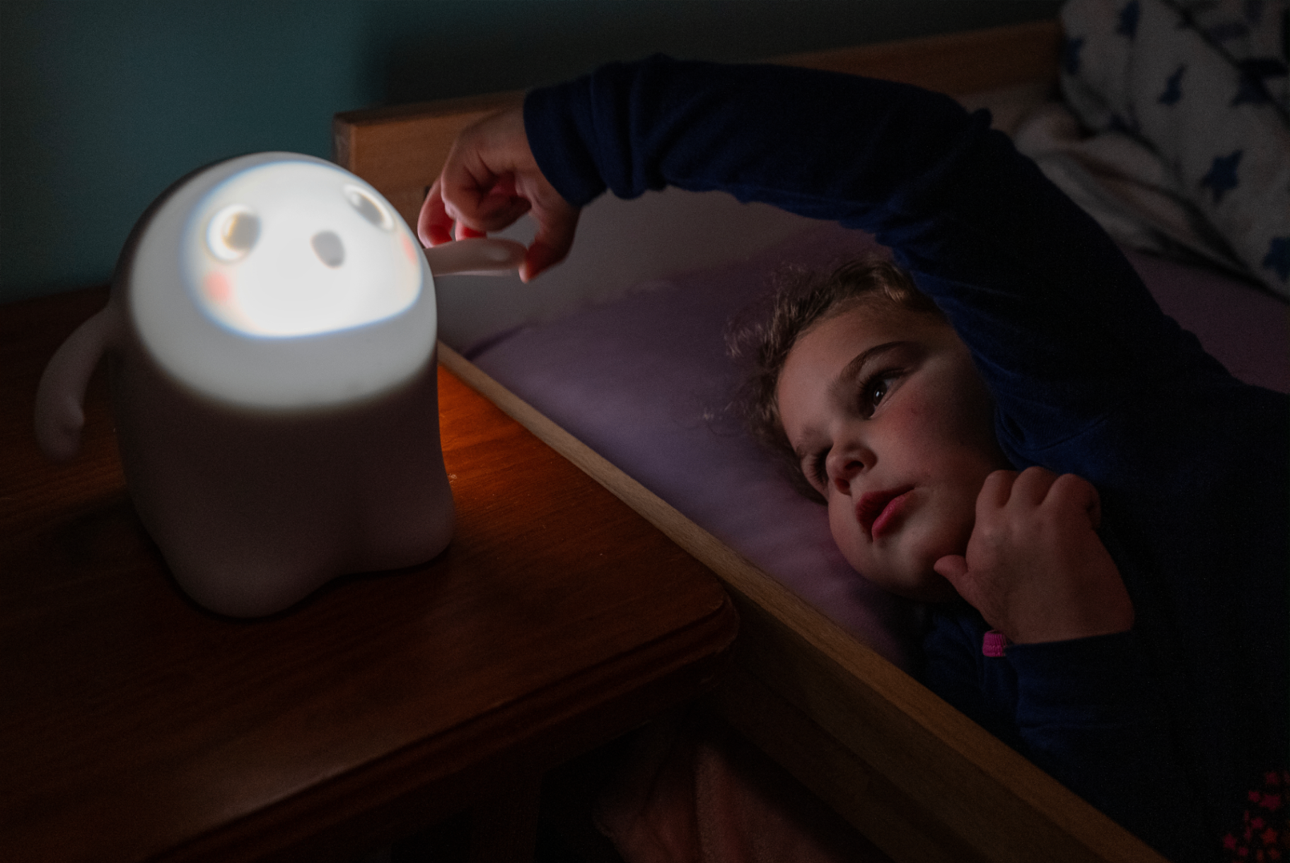 Child with Snorble on nightstand during bedtime routine