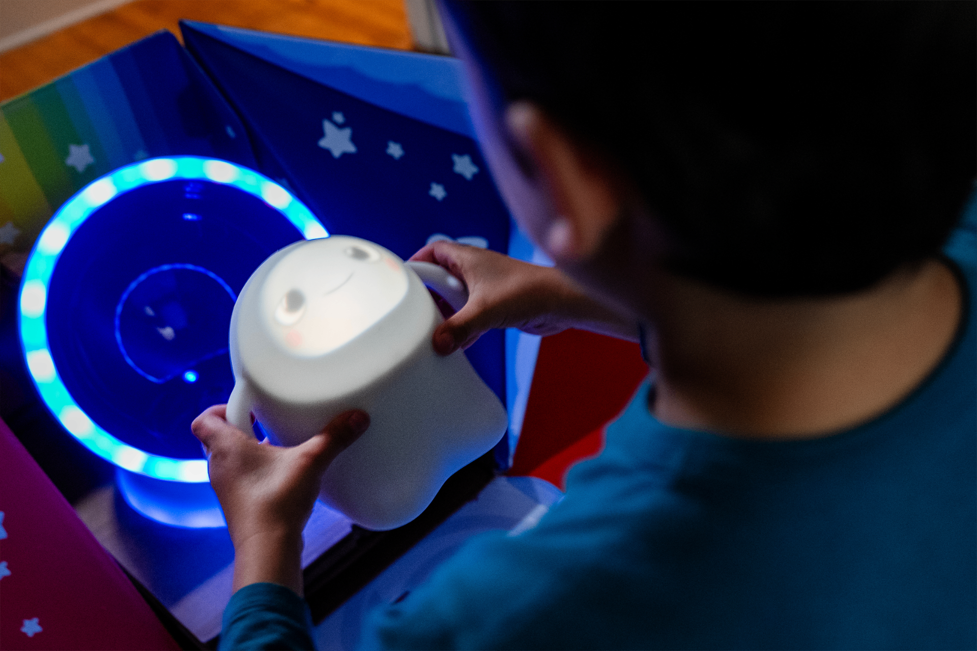 Child reaching for glowing Snorble at bedtime